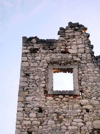 Ancient stone wall with one framed windowの写真素材