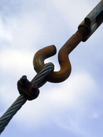 Old metallic rusted hook and metallic ropeの写真素材