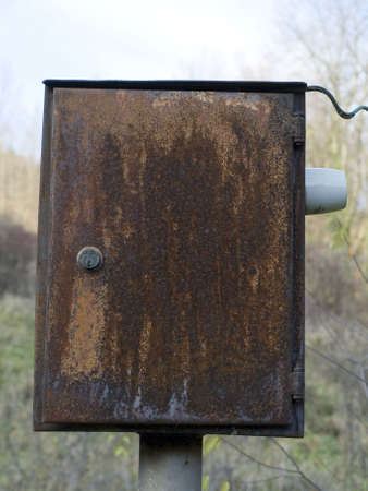 Old and rusted metallic box in the fieldの写真素材