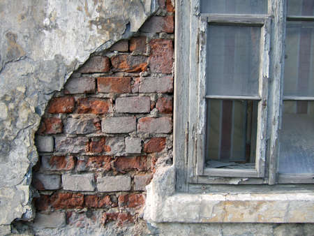 Detail of old house wall and wooden broken window