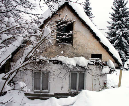 Old country house in deep white snowの写真素材
