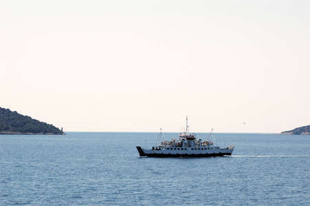 Touristic ferry boat in the sun on the Adriatic seaの写真素材