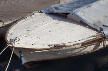 Part of  old wooden boat in small sea port