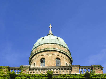 Old house metalic roof and stone crossの写真素材