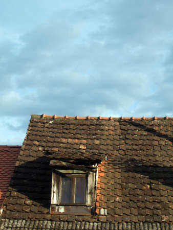 Old and ancient roof window and nice blue skyの写真素材