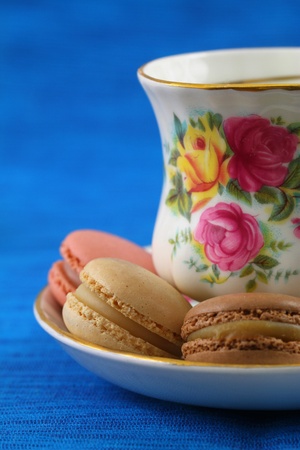 Macaroons and cup of tea on blue backgroundの写真素材