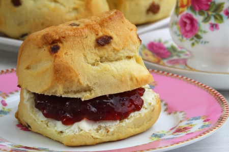 scone with strawberry jam and clotted cream, close upの写真素材