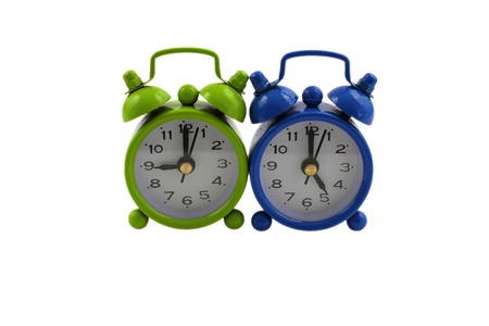 Working nine to five concept, two miniature clocks displaying time isolated on white