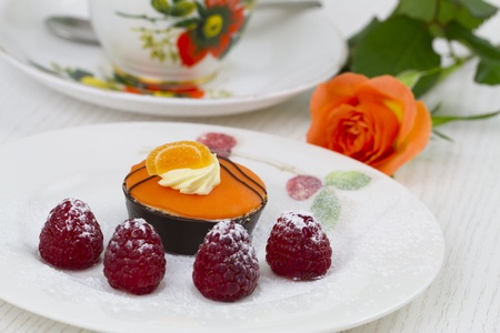 chocolate petit four with raspberries dusted with icing sugarの写真素材