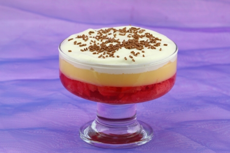 English strawberry trifle in sundae glass on purple backgroundの写真素材
