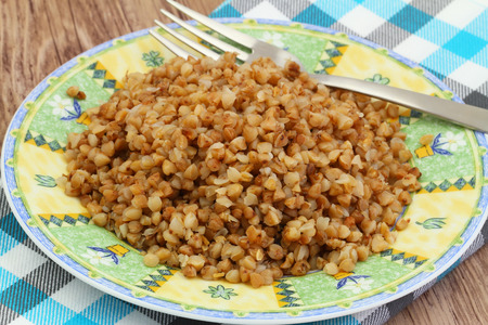 Cooked buckwheat on plate on checkered clothの写真素材