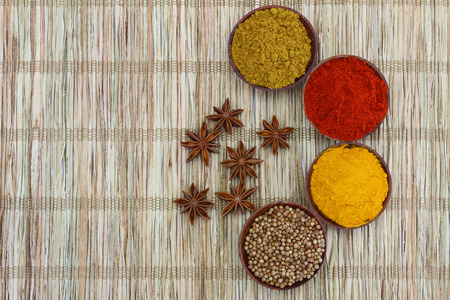 Selection of Indian spices on bamboo mat with copy spaceの写真素材