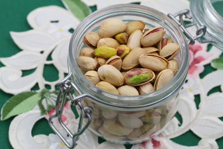 Pistachio nuts in vintage jar, close upの写真素材