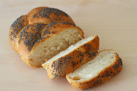 Sliced challah bread on wooden board
