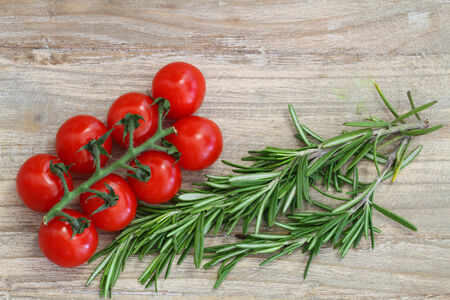 Cherry tomatoes and fresh rosemary with copy spaceの写真素材