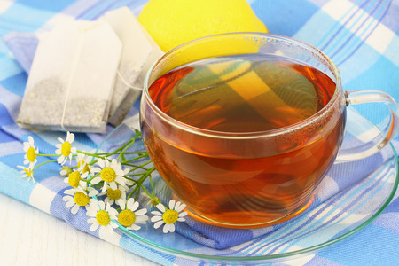 Chamomile tea with fresh chamomile flowers and lemonの写真素材