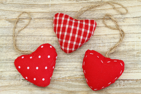 Red canvas hearts on wooden surfaceの写真素材