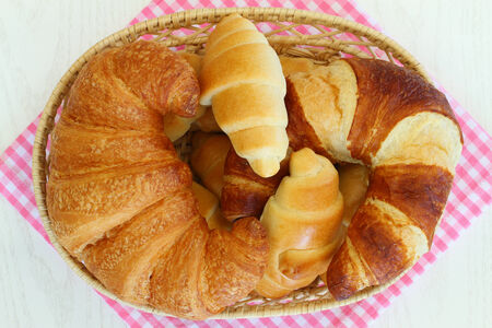 Selection of butter croissants in bread basketの写真素材