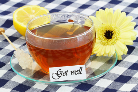 Get well card with cup of tea, lemon and cream gerbera daisyの写真素材