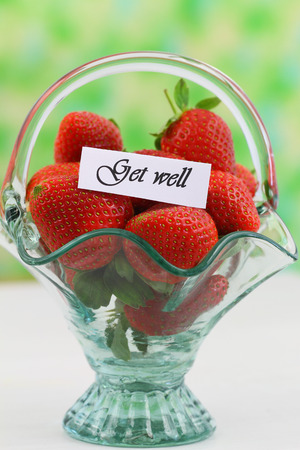 Get well card with fresh strawberries in vintage glass basketの写真素材