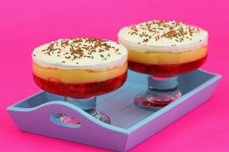 Strawberry trifle desserts on blue tray on pink backgroundの写真素材