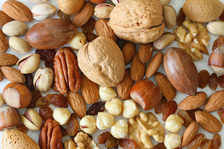 Selection of nuts, almonds and sultanas, close upの写真素材