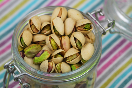 Pistachio nuts in vintage jar, close upの写真素材