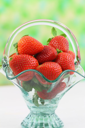 Fresh strawberries in vintage glass basket with copy spaceの写真素材