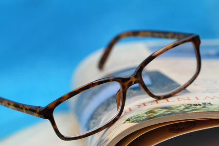 Glasses on open book with copy spaceの写真素材