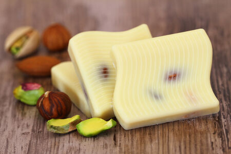 White chocolate pieces with almonds, pistachios and hazelnutsの写真素材