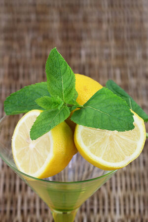 Lime and mint on wicker with copy spaceの写真素材