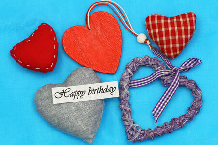 Happy birthday card with selection of colorful hearts on blue backgroundの写真素材
