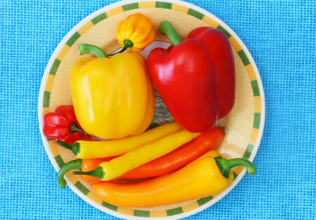 Bowl full of peppers and chili peppersの写真素材