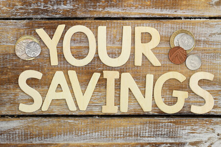 Your savings written with wooden letters on rustic surfaceの写真素材