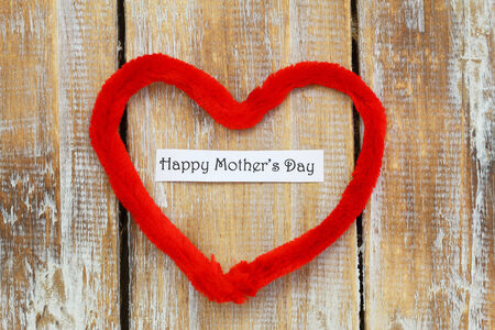 Happy Mother\'s day card with red heart on rustic wooden surfaceの写真素材