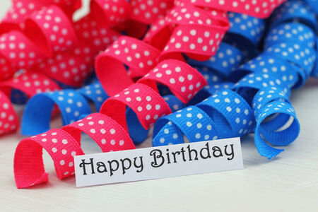 Happy birthday card with pink and blue ribbonの写真素材