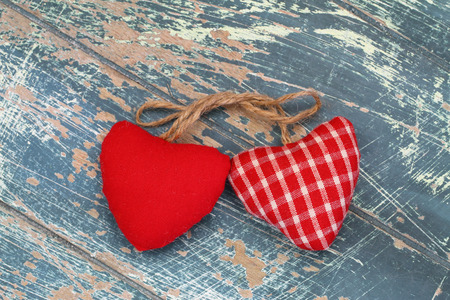 Two hearts on rustic wooden surfaceの写真素材