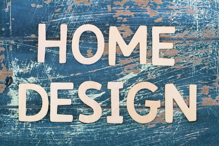 Home design written with wooden letters on rustic woodの写真素材
