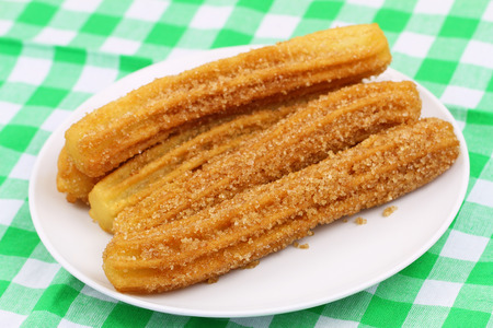Spanish churros on plate on checkered clothの写真素材
