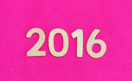 Year 2016 written with wooden letters on pink surfaceの写真素材