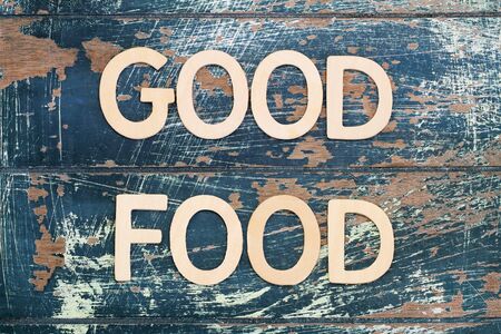 Good food written with wooden letters on rustic surfaceの写真素材