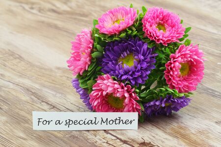 For a special Mother card with pink dahlia flowers on wooden surfaceの写真素材