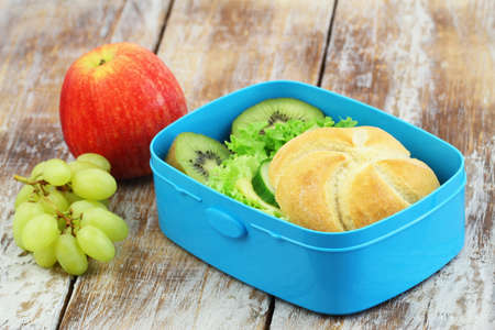 Healthy school lunch consisting of cheese sandwich and mixed fresh fruitの写真素材