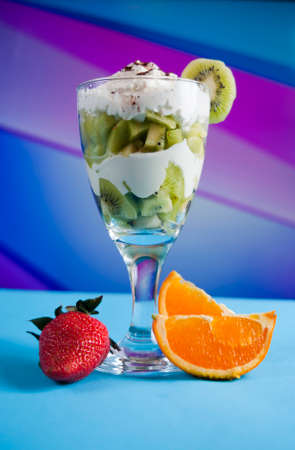 kiwi cocktail with orange, strawberry and whipped creamの写真素材