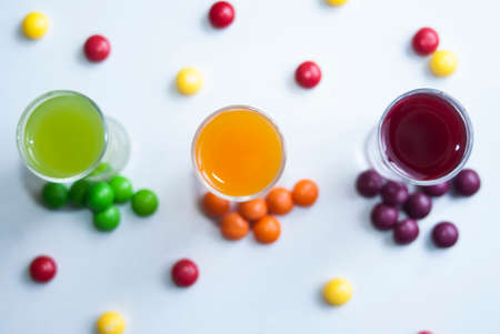 vodka in glasses with colorful candyの写真素材