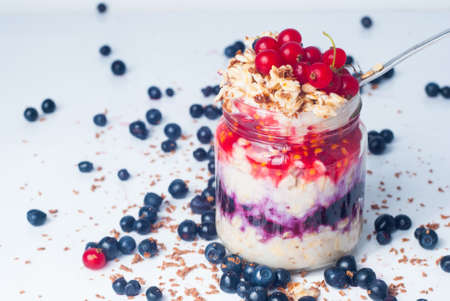 porridge with currants and chocolate on a light background
