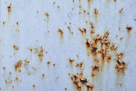 Traces of brown rust on blue metalの写真素材