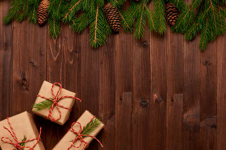 Christmas arrangement of gifts in Kraft paper on  wooden backgroundの写真素材