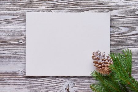 Christmas background of primed cardboard, twigs, pine cones on the Board