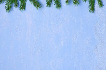 Christmas background of lace chantilly, fir branches  on  decorative plaster